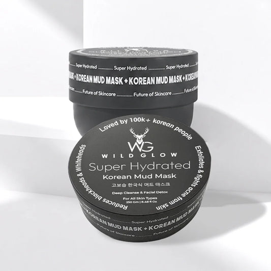 Two black cosmetic jars of Wild Glow Super Hydrated Korean Mud Mask stacked on a white background with soft shadows.