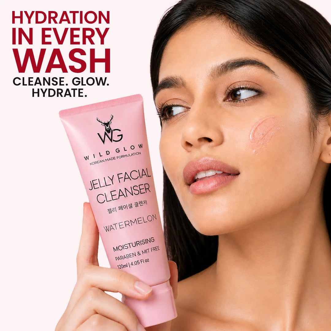 A woman holds a pink tube of Wild Glow Jelly Facial Cleanser Watermelon against a light background, with promotional text on the left side of the image.