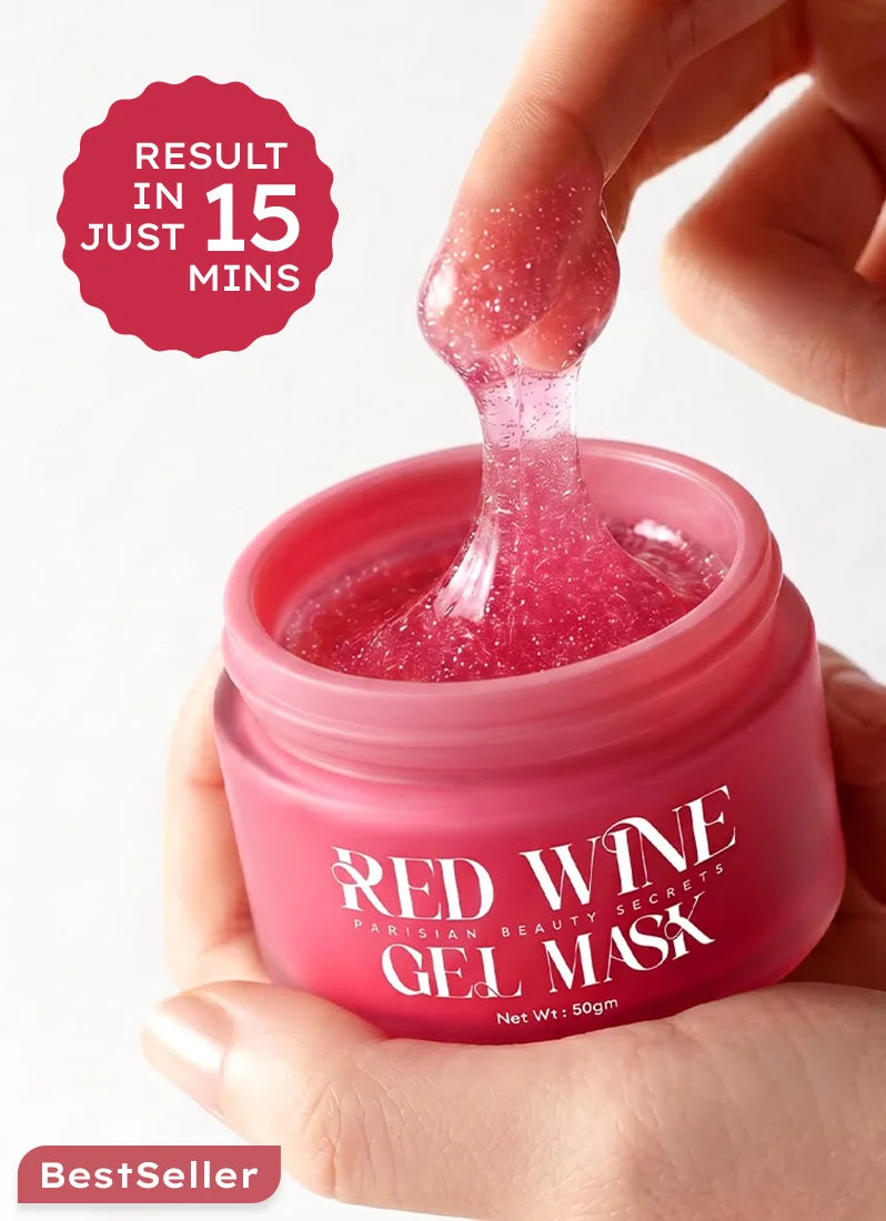 Red wine gel mask jar with pink gel being applied, on a white background.